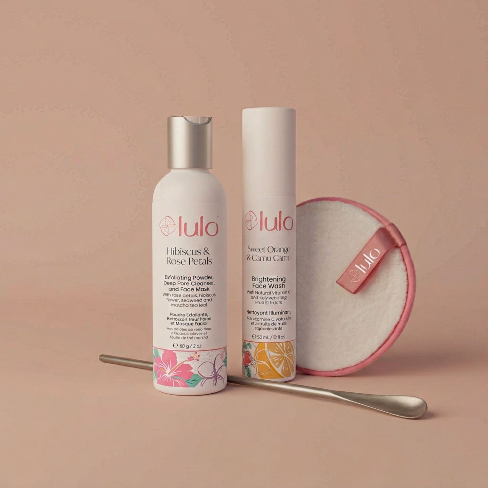 Luo Skin products including a bottle, an airless pump, a measuring spoon and round cleansing pad on a beige background